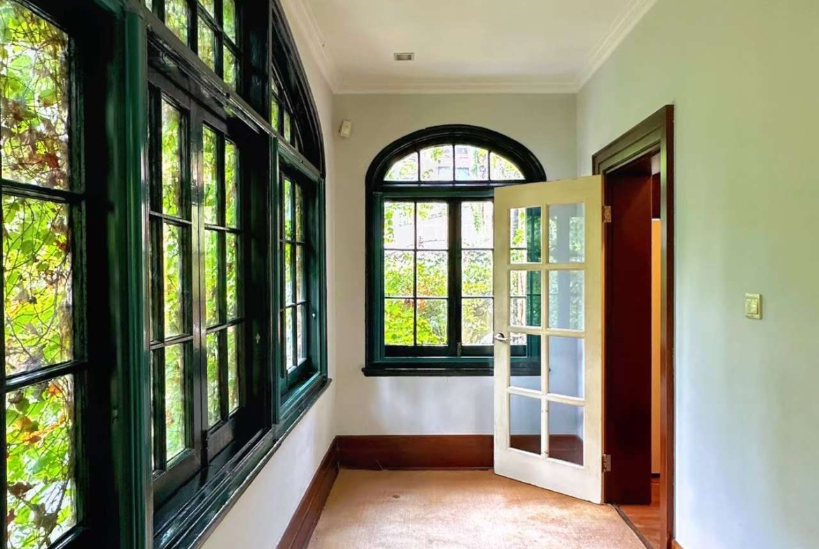 1928 heritage garden villa on protected Hunan Road. Main building first floor plus separate annex. 150 sqm private garden, garage included. 58,000 RMB/month.