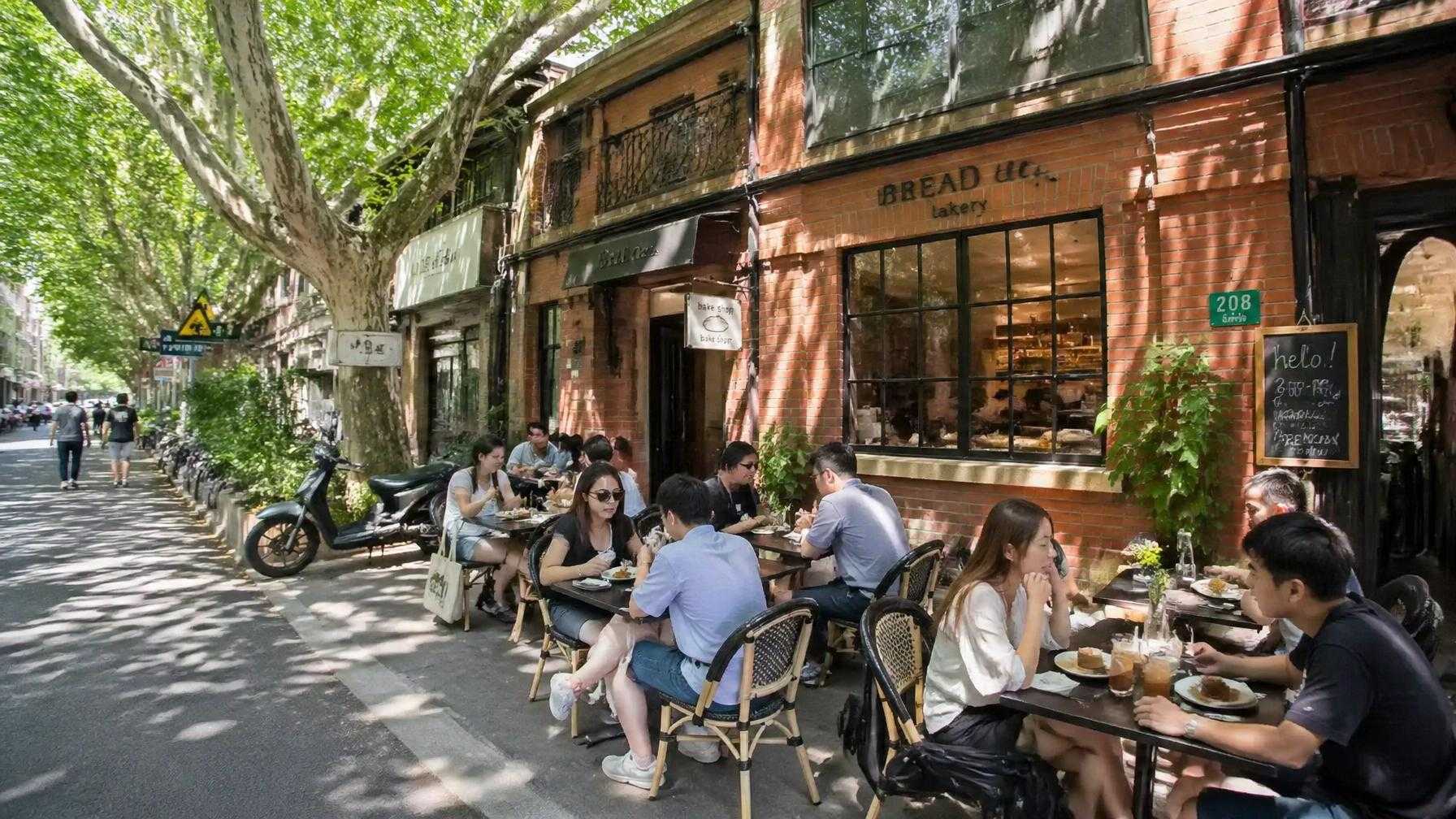 Expats and locals enjoying brunch at a sidewalk café on Anfu Road, Old Xuhui, with a converted lane house bakery in the background.