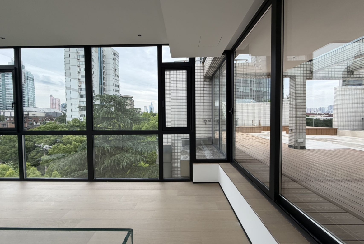 Top floor penthouse at The Summit in the Former French Concession. 5+1 bedrooms, 4 bathrooms, large private terrace. Steps from Anfu Road. 100,000 RMB/month.