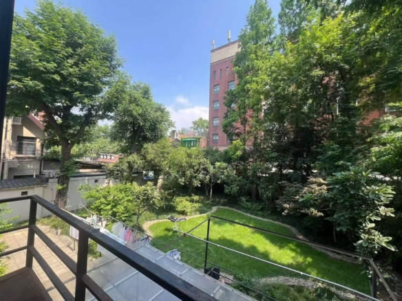 Garden lane house near Xiangshan Road and Sinan Road in Xintiandi. 110 sqm, 2 beds + walk-in closet, balcony, terrace, wall heating. 27,000 RMB/month.