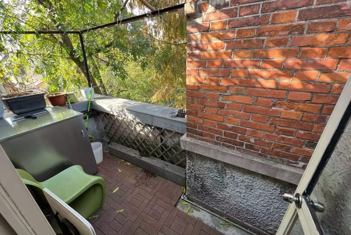 Authentic lane house apartment on Anfu Road with private balcony. 2 beds, 2 living rooms, heritage building, walk to cafes. 18,000 RMB/month.