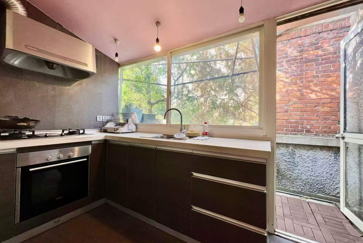 Authentic lane house apartment on Anfu Road with private balcony. 2 beds, 2 living rooms, heritage building, walk to cafes. 18,000 RMB/month.