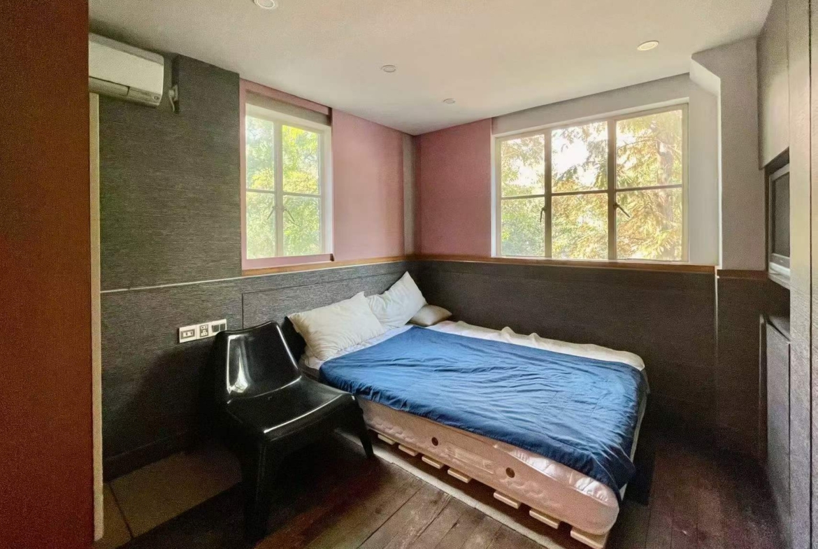Authentic lane house apartment on Anfu Road with private balcony. 2 beds, 2 living rooms, heritage building, walk to cafes. 18,000 RMB/month.