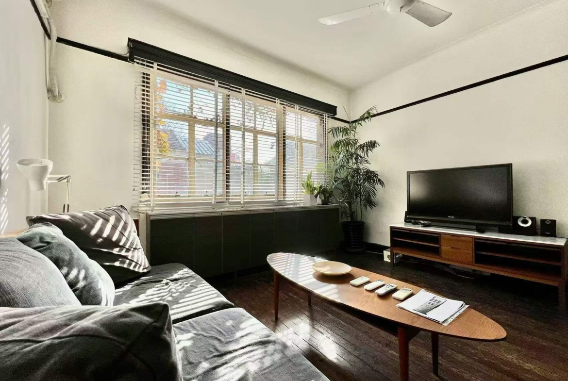 Authentic lane house apartment on Anfu Road with private balcony. 2 beds, 2 living rooms, heritage building, walk to cafes. 18,000 RMB/month.