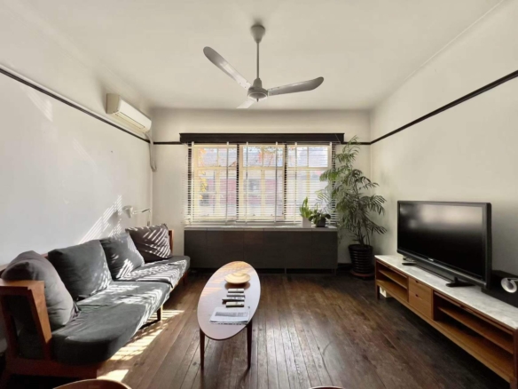 Authentic lane house apartment on Anfu Road with private balcony. 2 beds, 2 living rooms, heritage building, walk to cafes. 18,000 RMB/month.