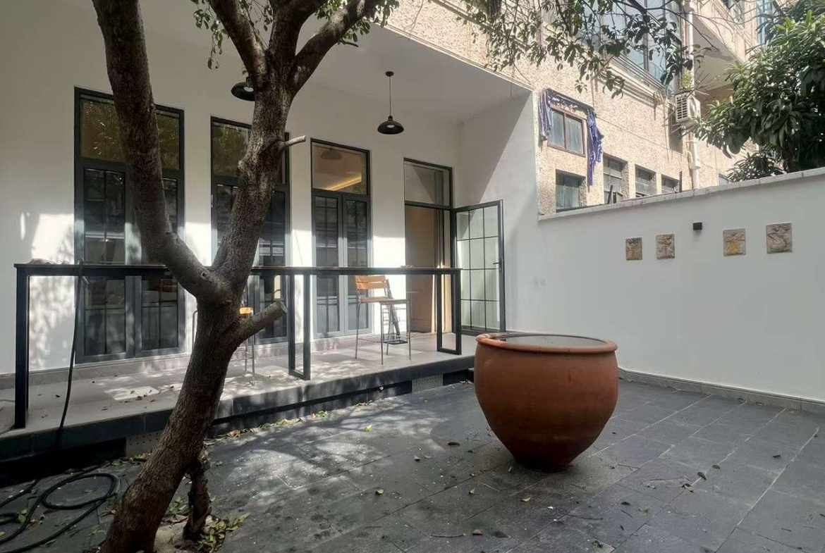 Ground floor lane house on North Urumqi Road with private garden. 100 sqm, 1 bed, 1 bath, 30 sqm garden. Live or work. 22,000 RMB/month.