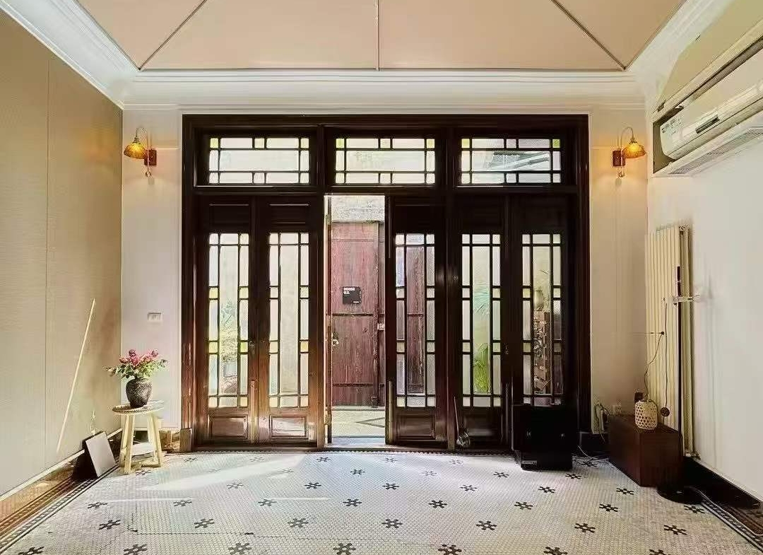 Entire protected lane house on Julu Road. 4 beds, 3 baths, 210 sqm, courtyard, terrace, wall heating. Live or work in the heart of Ju Fu Chang. 26,800 RMB/month.