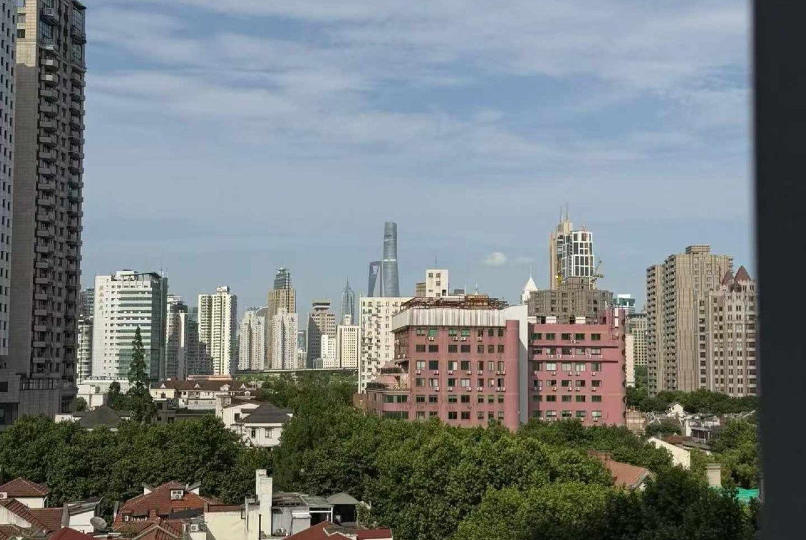 High floor 2-bed unit at Shanghai Grand Plaza on Julu Road. Southeast facing, Lujiazui skyline view, pool view, long-term lease available. 22,000 RMB/month.