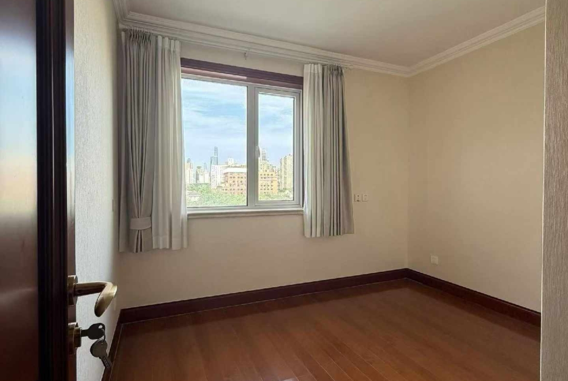 High floor 2-bed unit at Shanghai Grand Plaza on Julu Road. Southeast facing, Lujiazui skyline view, pool view, long-term lease available. 22,000 RMB/month.