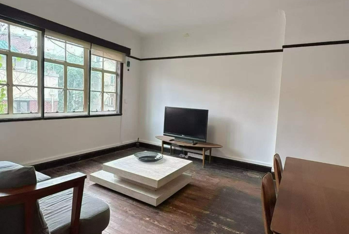 3rd floor unit on Anfu Road near Wukang Road. 2 beds, 2 living rooms, 1 bath, north-south through, private balcony. Prime FFC location. 17,000 RMB/month.
