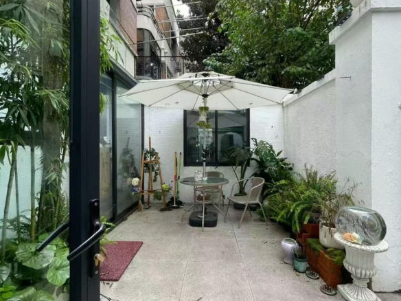 Ground floor studio at Nanhua Xincun on Changle Road. 120 sqm, double south-facing, 30 sqm garden. Ideal for creative studio or office. 22,500 RMB/month.
