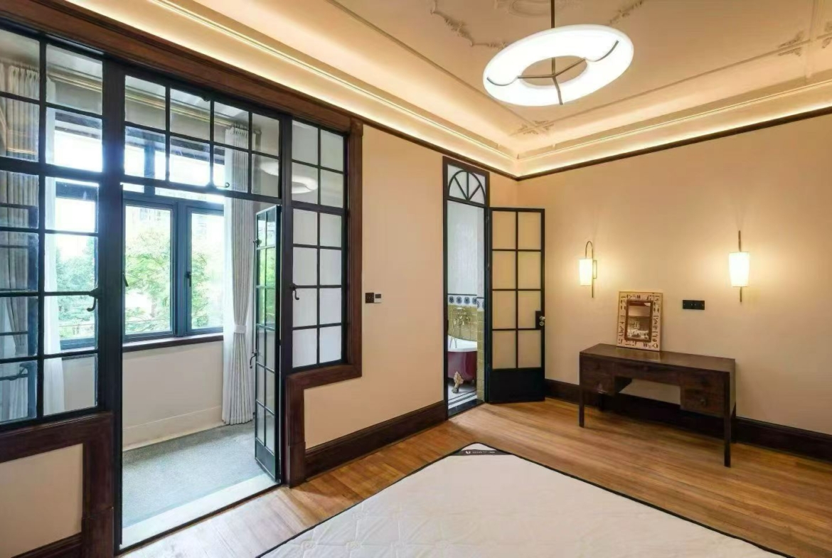 2-bed, 2-bath heritage unit at Pass Apartment on Changshu Road. 150 sqm, 80 sqm terrace, original fireplace, first rental. Steps from metro. 42,800 RMB/month.