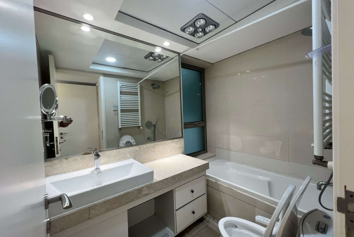 2-bed, 2-bath unit at Eight Park Avenue in Jing'an. 110 sqm, central AC, underfloor heating, clubhouse with pool and gym. 25,800 RMB/month.