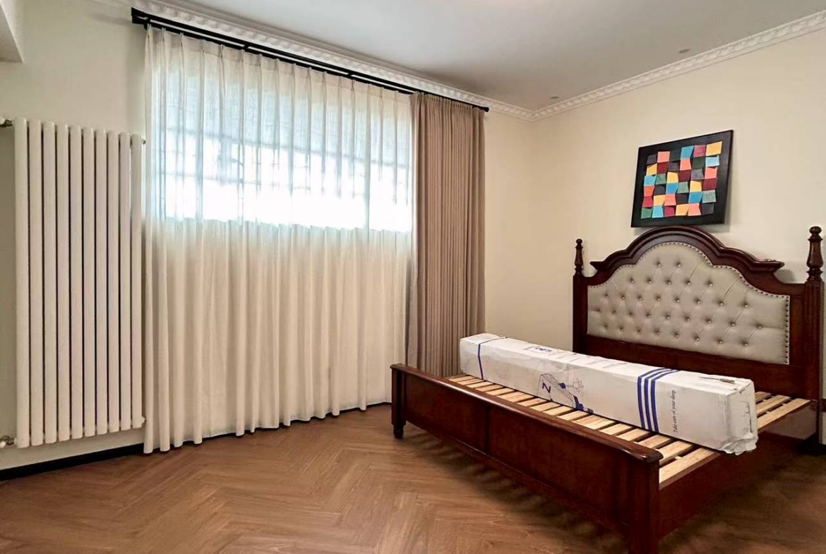 4th floor heritage apartment on Huaihai Road. 2 beds, 2 baths, 3.3m ceilings, central AC, wall heating, smart toilet. Steps from Changshu Road Station. 33,800 RMB/month.