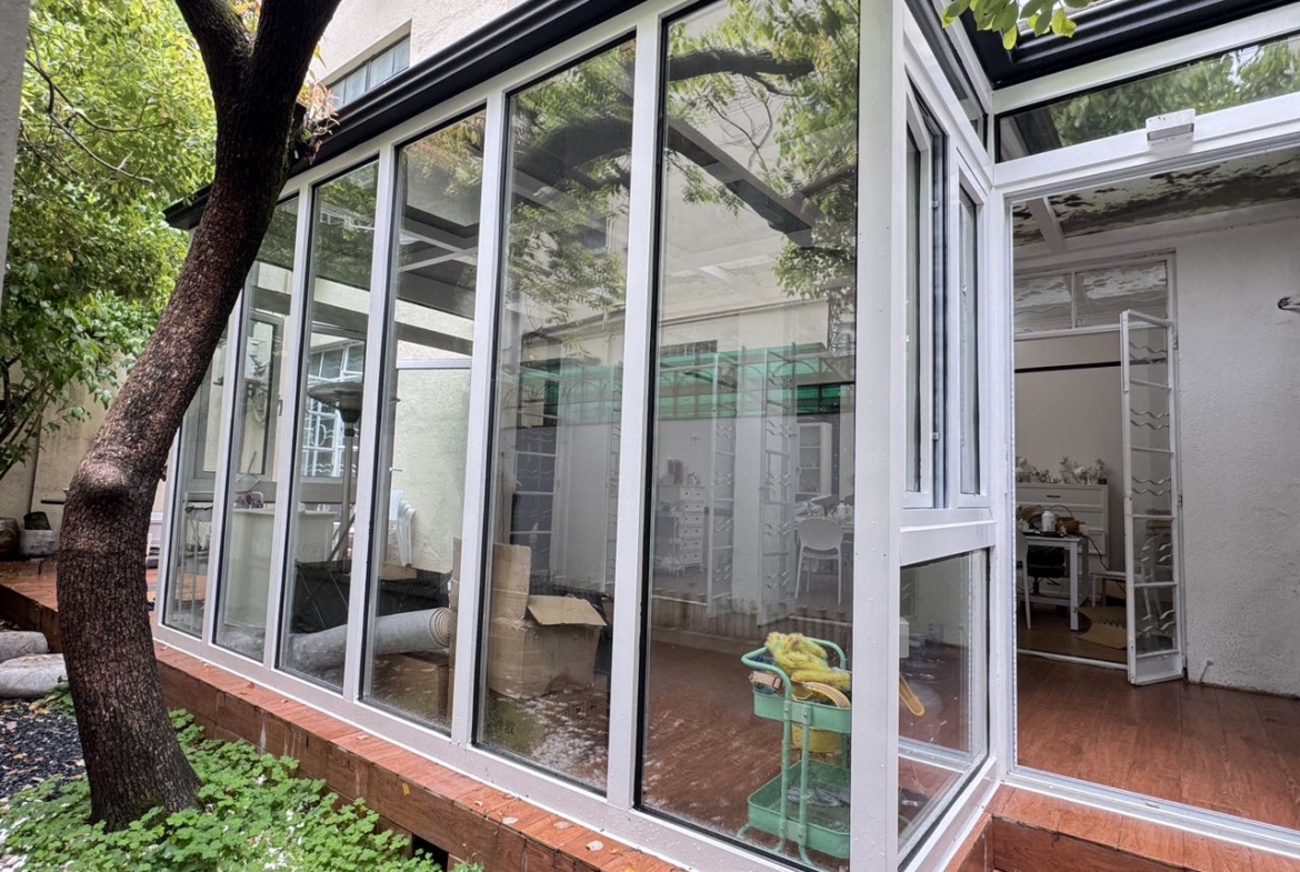Ground floor studio at Shangfang Garden on Huaihai Road. 70 sqm, 20 sqm garden, 3 flexible rooms, steps from Changshu Road Station. 21,600 RMB/month.
