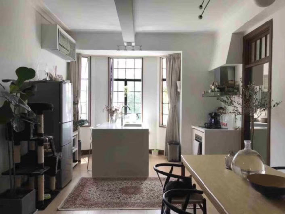 2-bed, 1-bath unit at Zhenliu Apartment on Huashan Road. 1930 heritage elevator building with 2,500 sqm garden, high ceilings. Home to Zhou Xuan. 23,000 RMB/month.