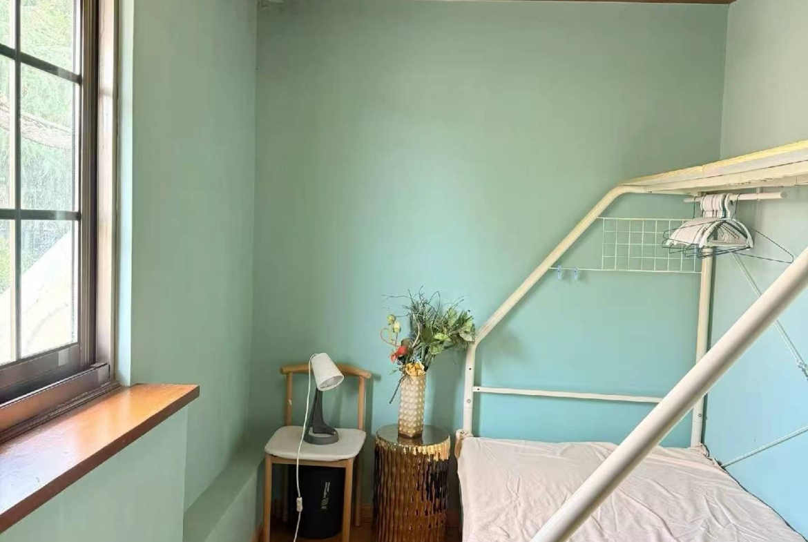 2-bed, 1-bath unit at Aitang Xincun on YUqing Road. 100 sqm, private terrace, heritage building, owner direct. Near Shanghai Library Station. 18,000 RMB/month.