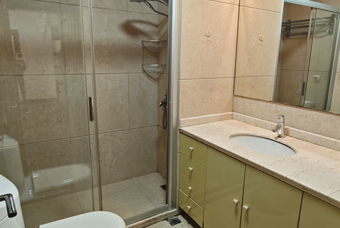 2-bed, 2-bath unit at Ladoll International City near Jing'an Sculpture Park. 120 sqm, south-facing, balcony, central AC. Available August 14. 19,800 RMB/month.
