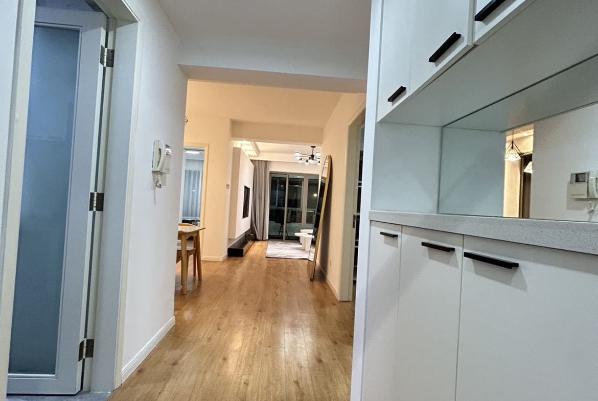 2-bed, 2-bath unit at One Park Avenue in Jing'an. 110 sqm, underfloor heating, central AC, oven, dishwasher. 50% greenery, clubhouse. 22,600 RMB/month.