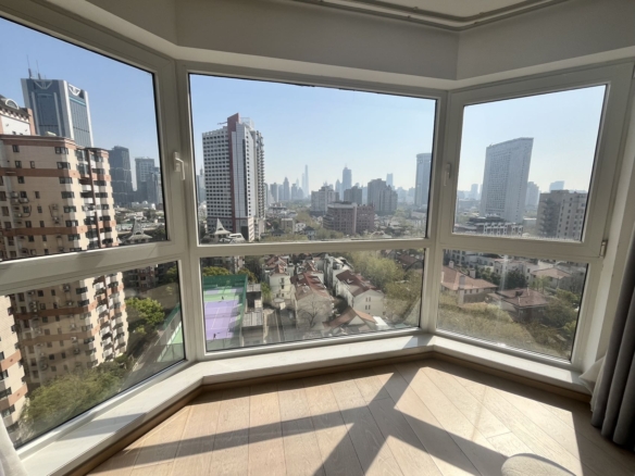 2-bed, 2-bath unit at Shanghai Grand Plaza on Julu Road. 114 sqm, underfloor heating, central AC, clubhouse with pool. 25,000 RMB/month.