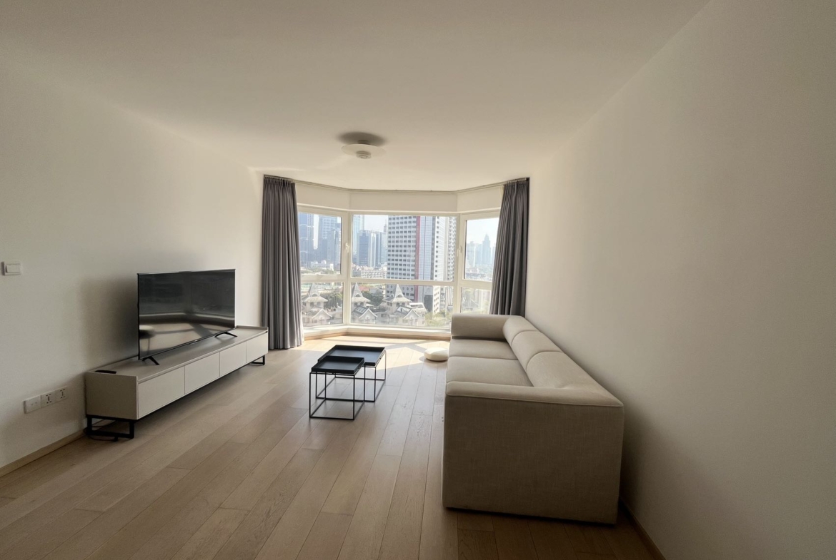 2-bed, 2-bath unit at Shanghai Grand Plaza on Julu Road. 114 sqm, underfloor heating, central AC, clubhouse with pool. 25,000 RMB/month.