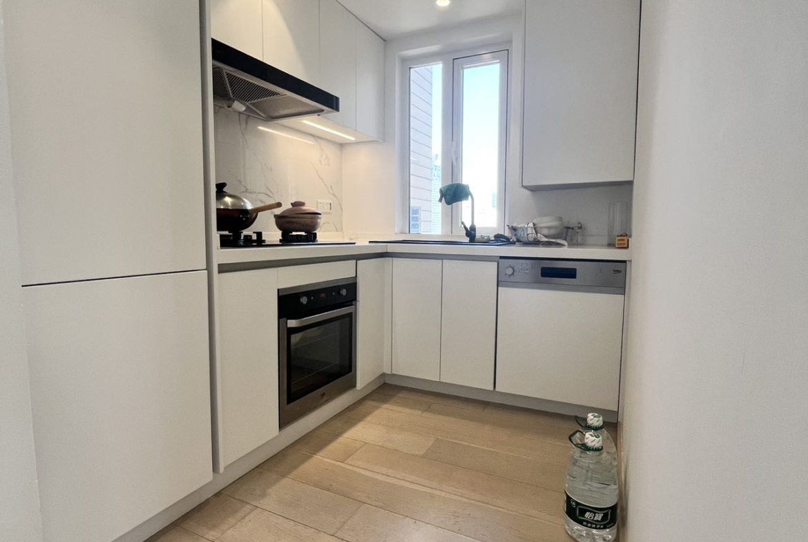 2-bed, 2-bath unit at Shanghai Grand Plaza on Julu Road. 114 sqm, underfloor heating, central AC, clubhouse with pool. 25,000 RMB/month.