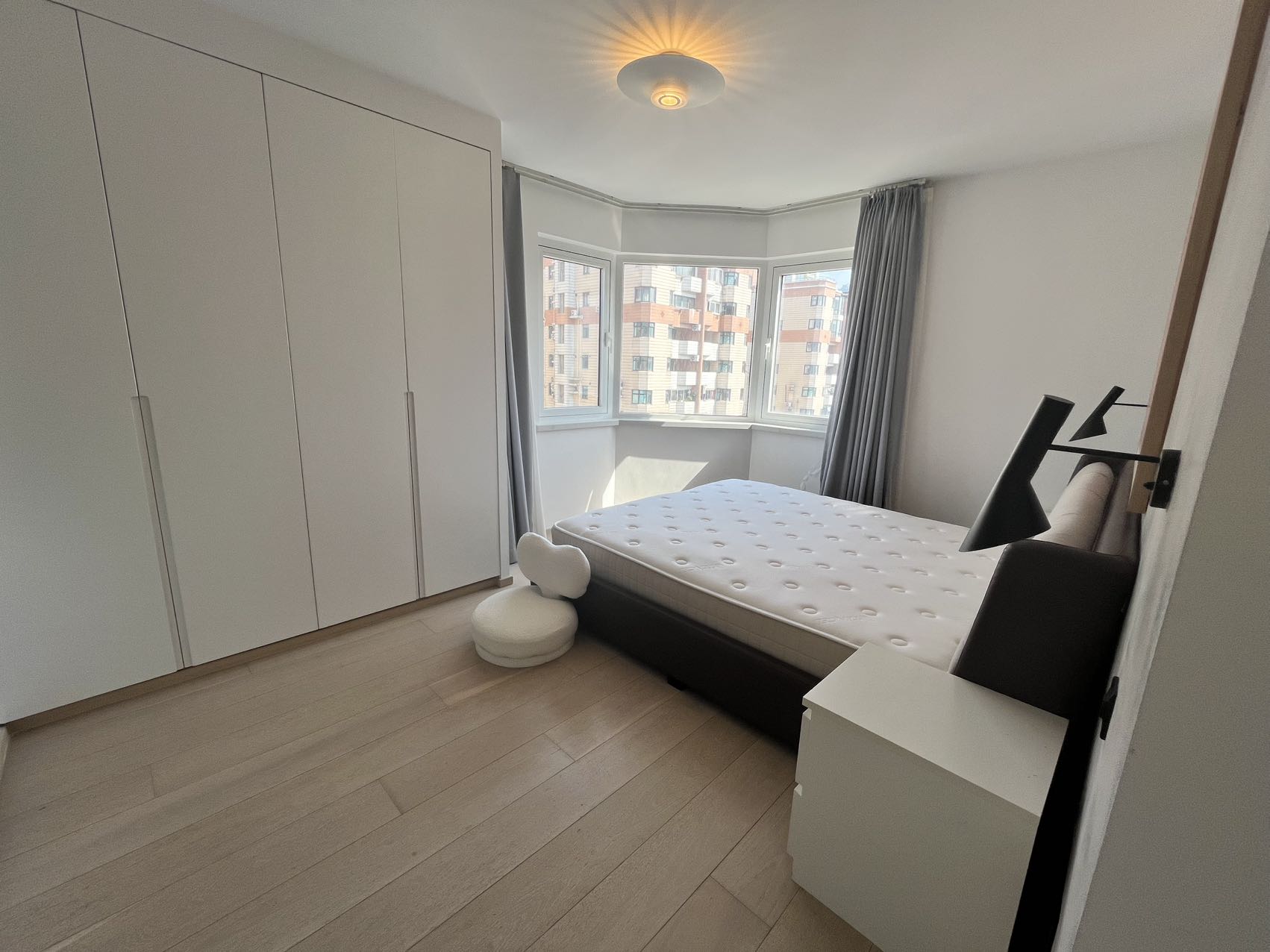 2-bed, 2-bath unit at Shanghai Grand Plaza on Julu Road. 114 sqm, underfloor heating, central AC, clubhouse with pool. 25,000 RMB/month.