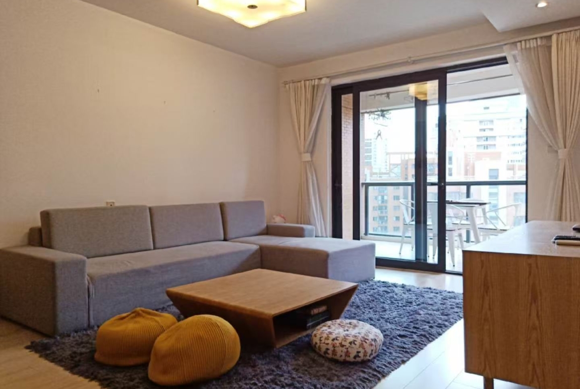 2-bed, 2-living, 1-bath unit at Territory Shanghai. 118 sqm, south-facing balcony, central Jing'an location near Nanjing West Road. 19,000 RMB/month.