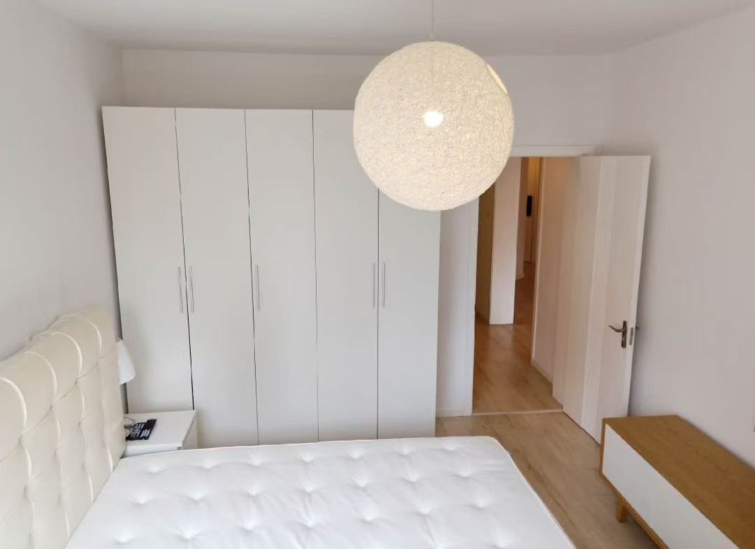 2-bed, 2-living, 1-bath unit at Territory Shanghai. 118 sqm, south-facing balcony, central Jing'an location near Nanjing West Road. 19,000 RMB/month.