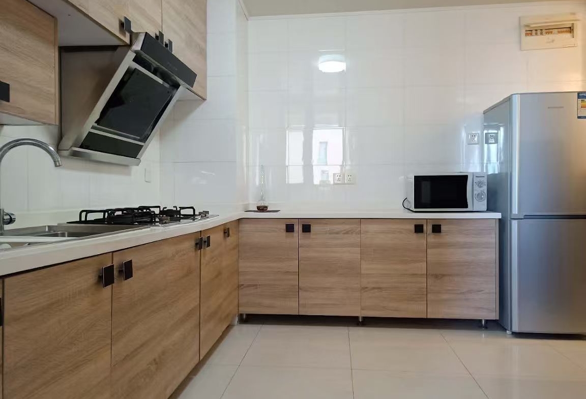2-bed, 2-living, 1-bath unit at Territory Shanghai. 118 sqm, south-facing balcony, central Jing'an location near Nanjing West Road. 19,000 RMB/month.