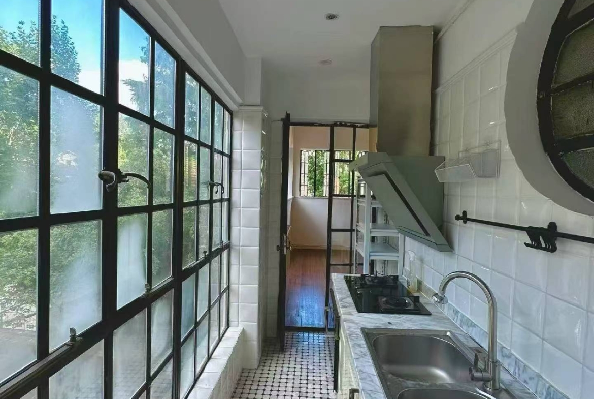 1-bed, 1-bath lane house on Yueyang Road with sunroom and private terrace. Heritage FFC location. 15,800 RMB/month.