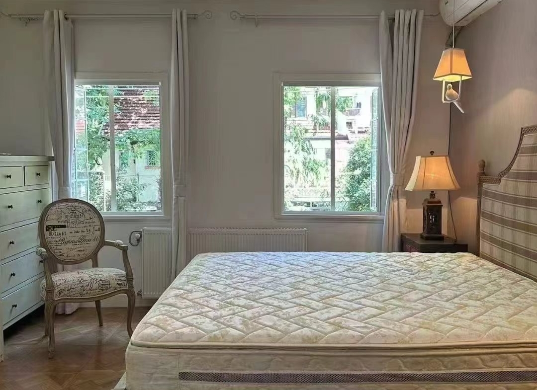 2-bed, 2-bath garden unit on Pingwu Road. 3.3m ceilings, north-south through, wall heating, garden views. 13,000 RMB/month.