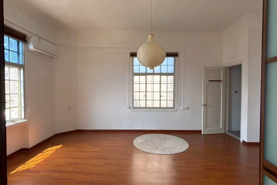 1-bed, 1-bath unit at Rui Hua Apartment on Changshu Road. 87 sqm, double south-facing, elevator, heritage building (1928), city views. 11,000 RMB/month.