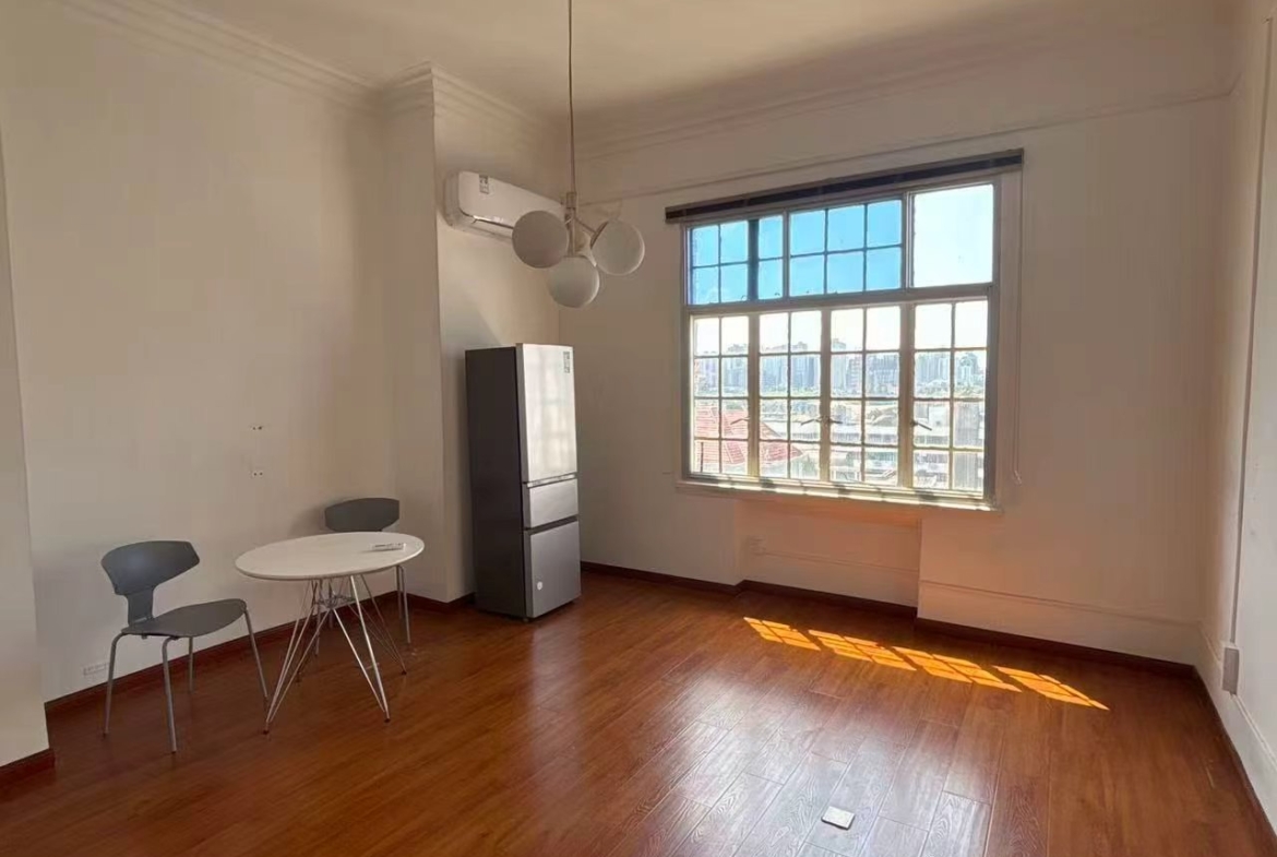 1-bed, 1-bath unit at Rui Hua Apartment on Changshu Road. 87 sqm, double south-facing, elevator, heritage building (1928), city views. 11,000 RMB/month.
