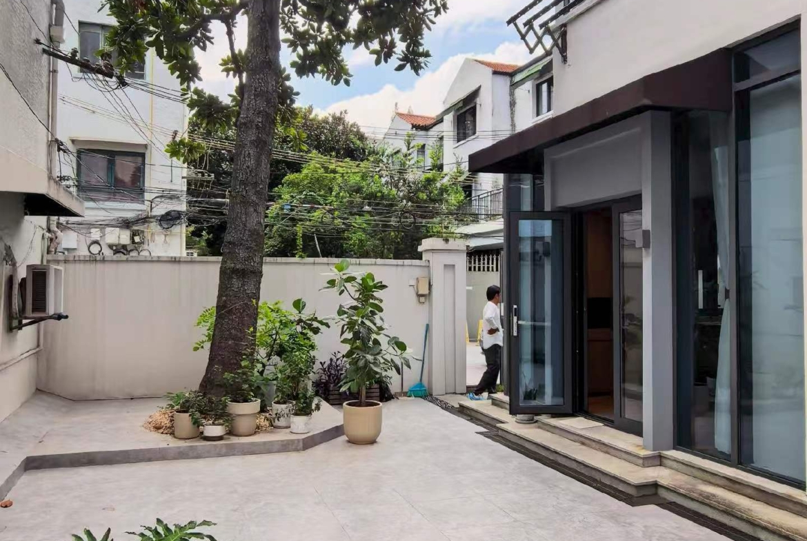 Ground floor lane house on Wuyuan Road with 60 sqm private garden and parking. 1 bed, 1 bath, fully renovated, live or work. 28,000 RMB/month.
