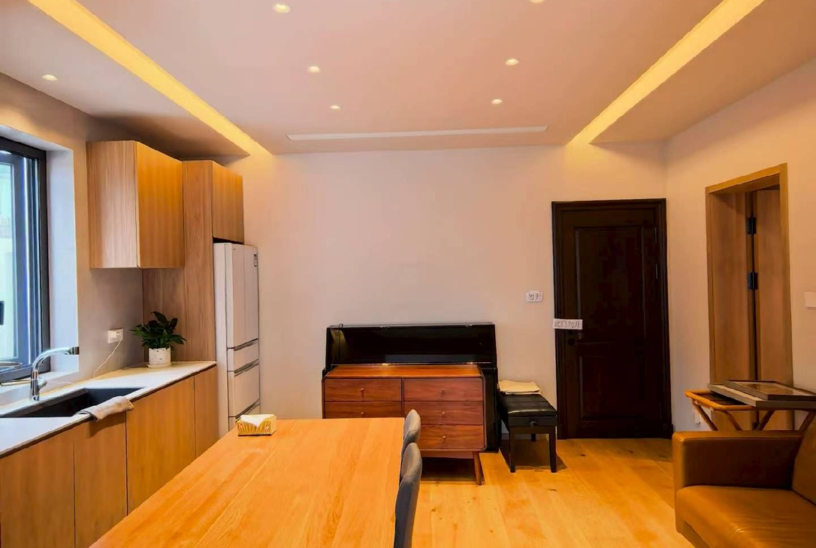 Ground floor lane house on Wuyuan Road with 60 sqm private garden and parking. 1 bed, 1 bath, fully renovated, live or work. 28,000 RMB/month.
