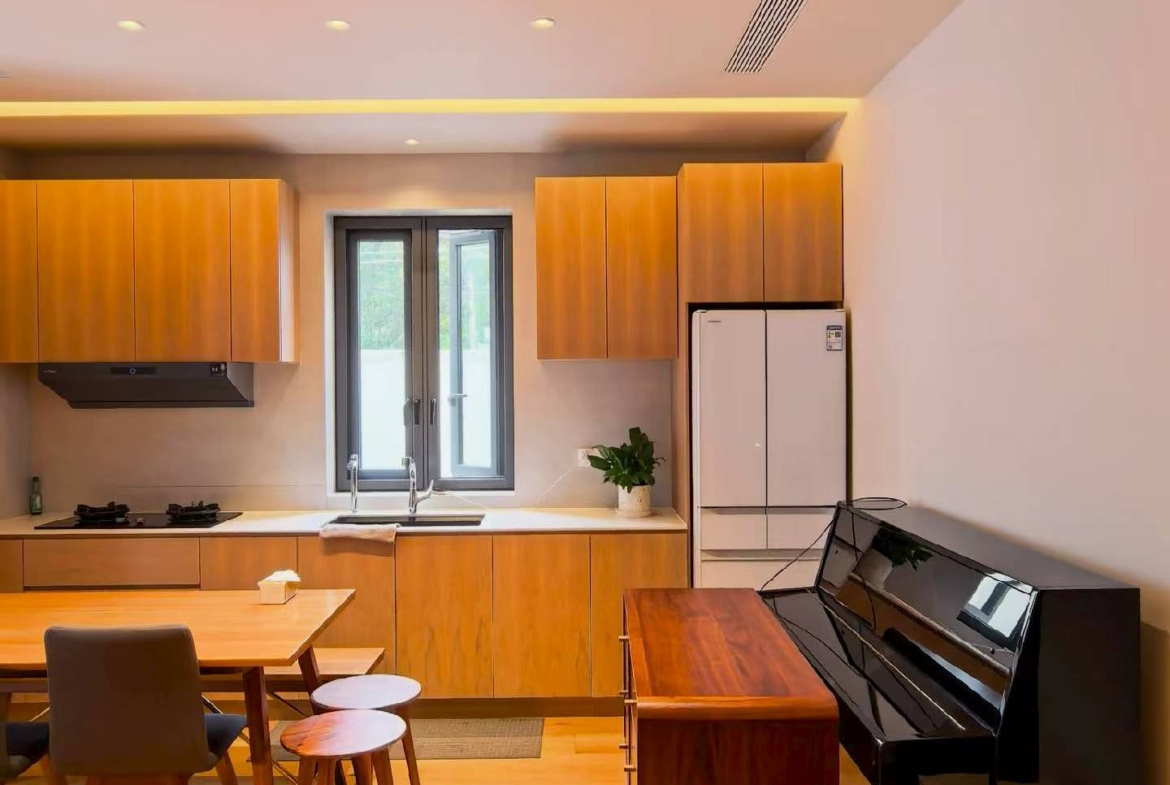 Ground floor lane house on Wuyuan Road with 60 sqm private garden and parking. 1 bed, 1 bath, fully renovated, live or work. 28,000 RMB/month.