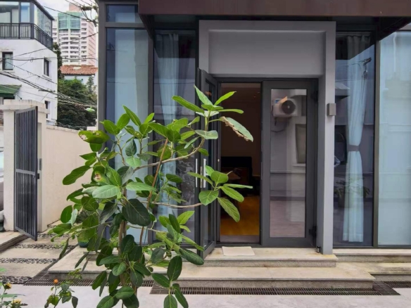 Ground floor lane house on Wuyuan Road with 60 sqm private garden and parking. 1 bed, 1 bath, fully renovated, live or work. 28,000 RMB/month.