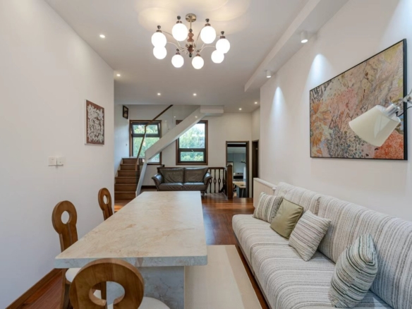 Designer-renovated heritage lane house at 601 Fuxing Middle Road. 3 beds, 2 baths, terrace with awning, attic, central AC, underfloor heating. 32,500 RMB/month.