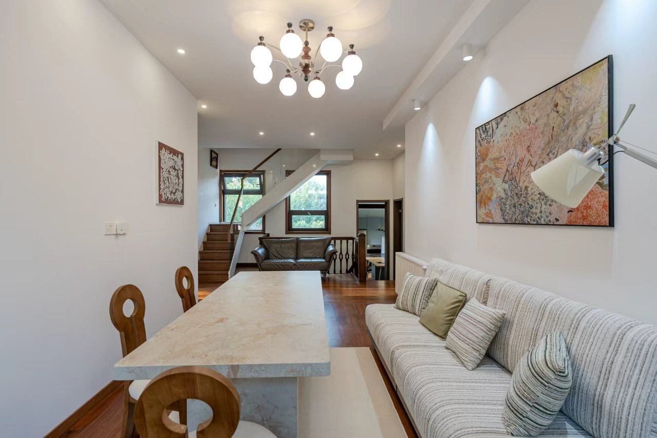 Designer-renovated heritage lane house at 601 Fuxing Middle Road. 3 beds, 2 baths, terrace with awning, attic, central AC, underfloor heating. 32,500 RMB/month.