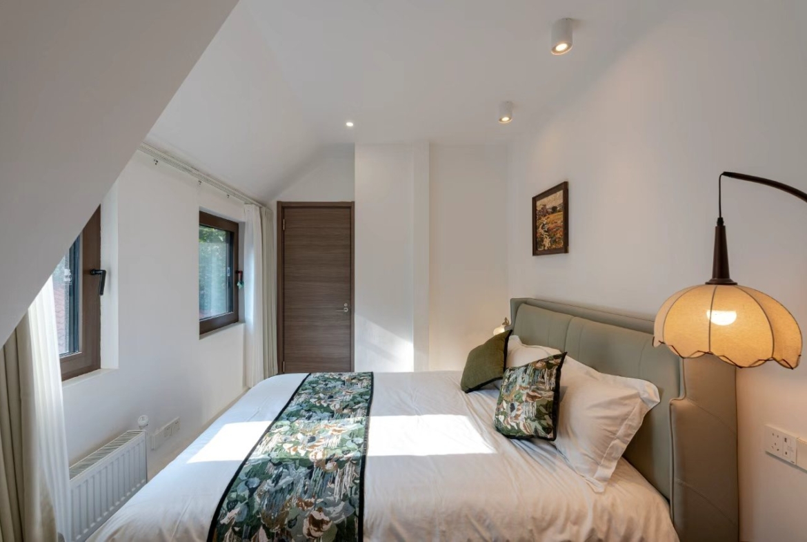 Designer-renovated heritage lane house at 601 Fuxing Middle Road. 3 beds, 2 baths, terrace with awning, attic, central AC, underfloor heating. 32,500 RMB/month.