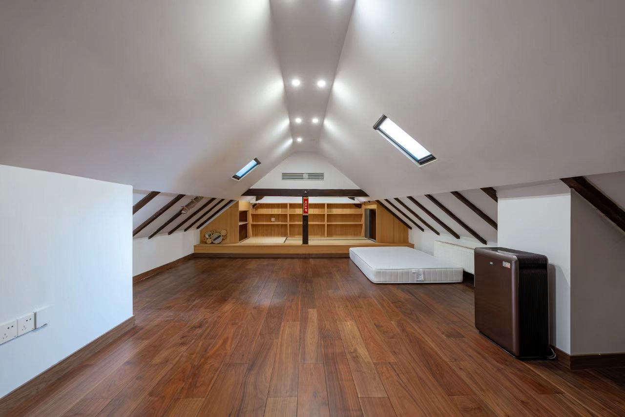 Designer-renovated heritage lane house at 601 Fuxing Middle Road. 3 beds, 2 baths, terrace with awning, attic, central AC, underfloor heating. 32,500 RMB/month.