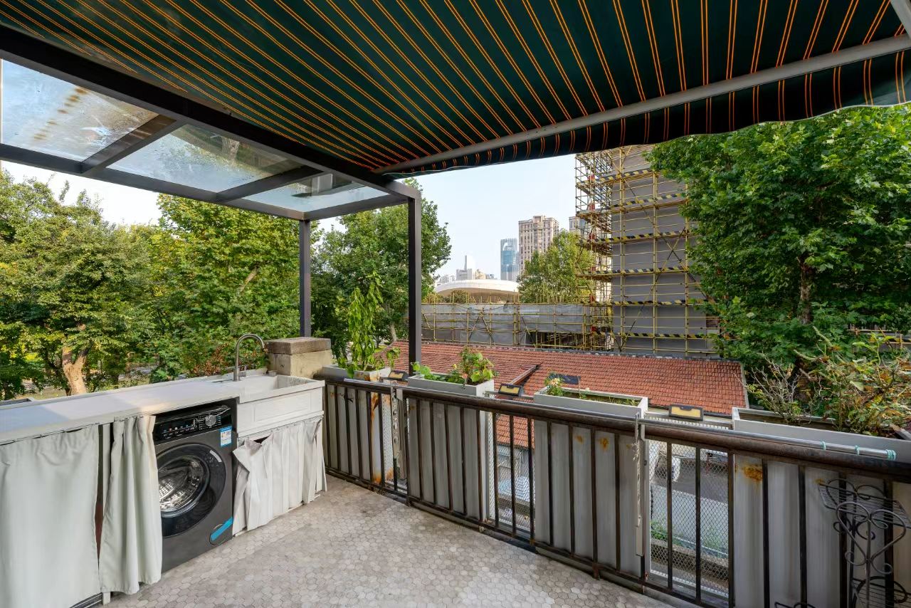 Designer-renovated heritage lane house at 601 Fuxing Middle Road. 3 beds, 2 baths, terrace with awning, attic, central AC, underfloor heating. 32,500 RMB/month.