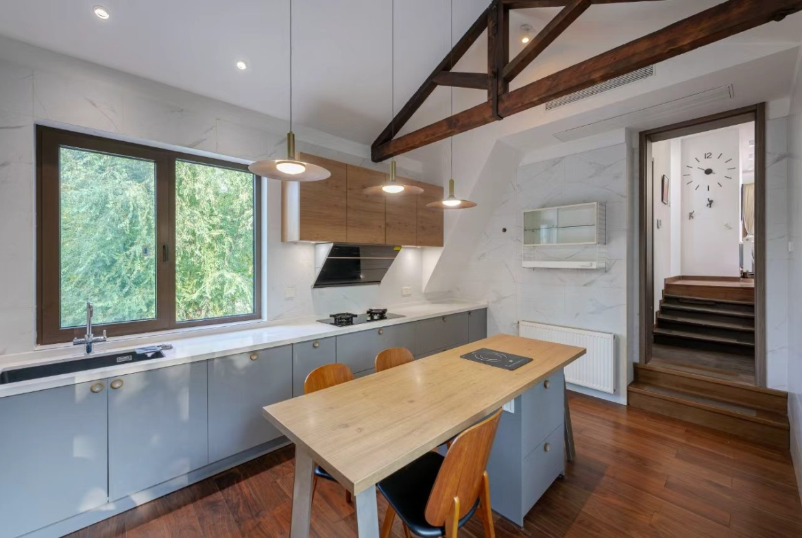 Designer-renovated heritage lane house at 601 Fuxing Middle Road. 3 beds, 2 baths, terrace with awning, attic, central AC, underfloor heating. 32,500 RMB/month.