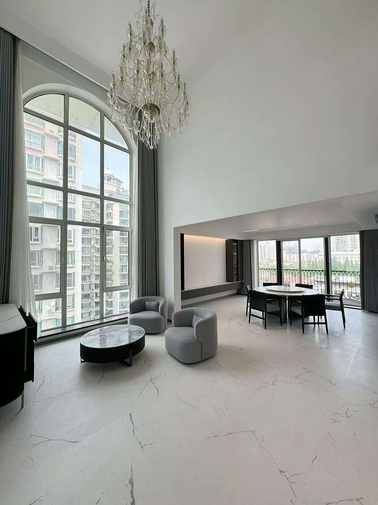 Rare 318 sqm top-floor duplex at Garland Service Apartment (新华嘉利阳光豪庭) in Changning. 4+1 beds, double-height living room, terrace, central AC, floor heating, fresh air. 65,000 RMB/month.