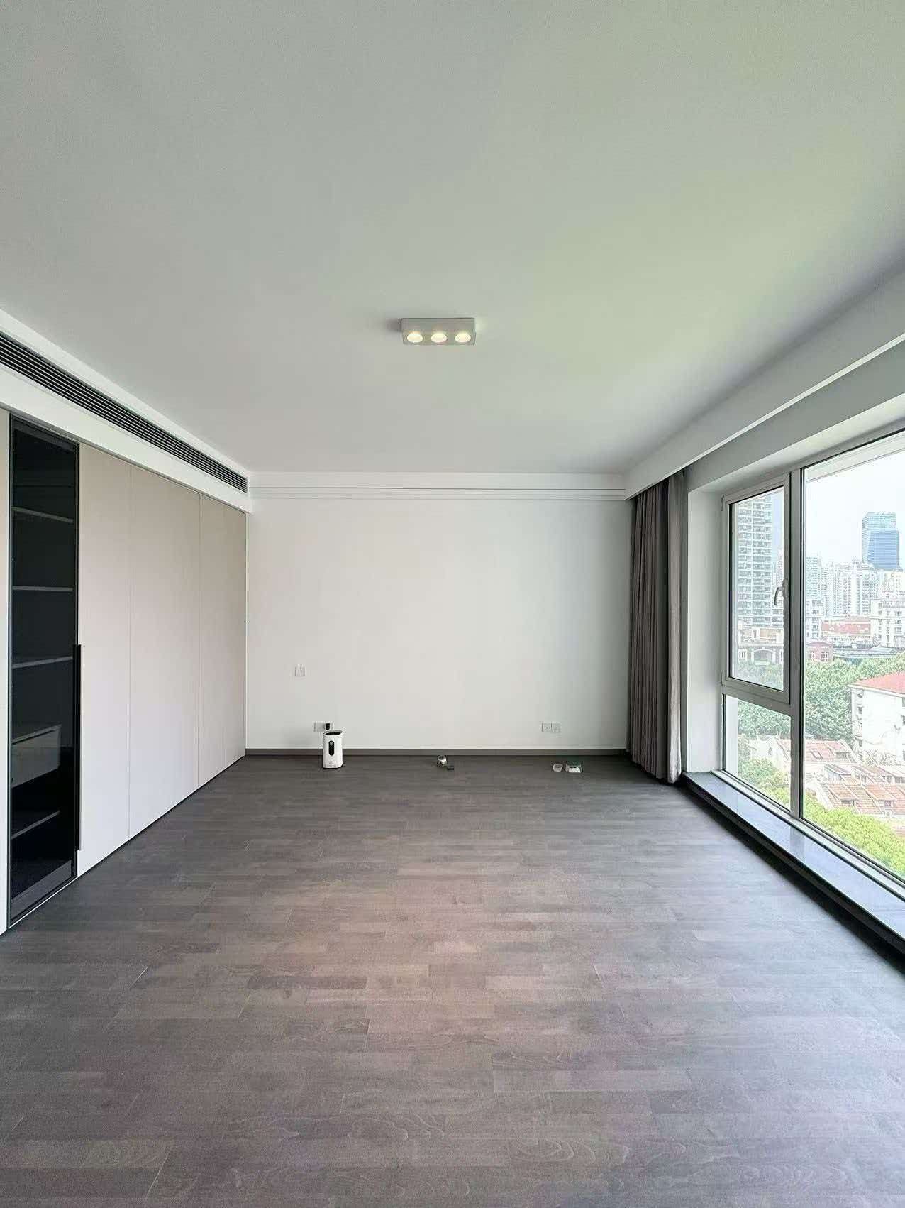 Rare 318 sqm top-floor duplex at Garland Service Apartment (新华嘉利阳光豪庭) in Changning. 4+1 beds, double-height living room, terrace, central AC, floor heating, fresh air. 65,000 RMB/month.