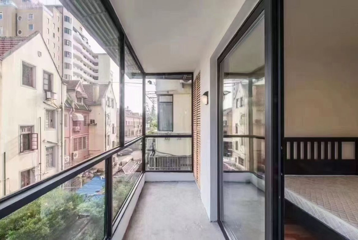 2-bed, 2-bath unit on Huaihai Middle Road near Changshu Road. 120 sqm, 10 sqm balcony, underfloor heating, central AC. Steps from Lines 1, 7, and 10. 13,500 RMB/month.